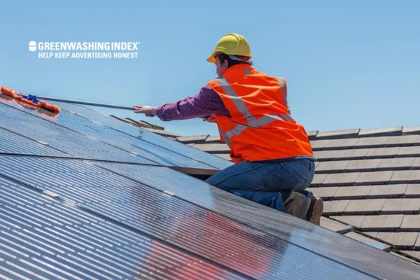 worker cleaning solar panels