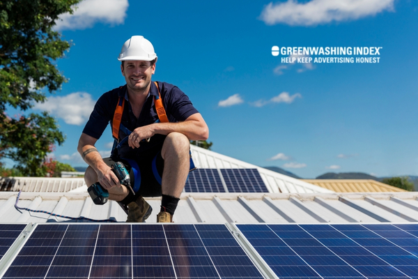 Worker installing solar panels on a roof
